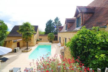 the pool area and both houses from the main terrace area above the pool 