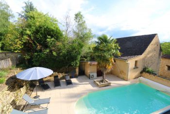 The pool area and cottage from the third bedroom window