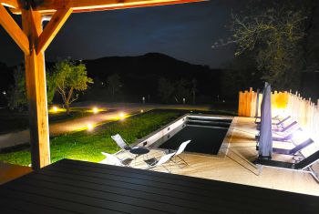 The pool area and terrace at night 